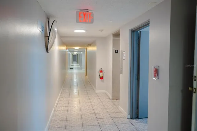 an empty room with wooden floor and a window