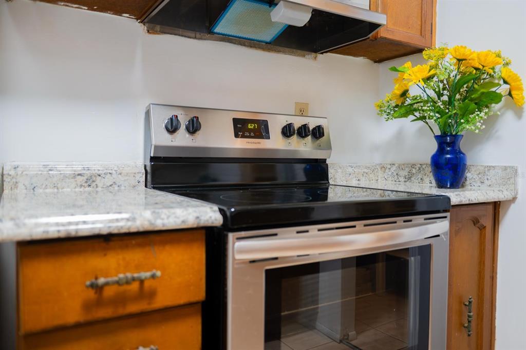 1902 Honour Road, Unit 23 Orlando, FL 32839 - Photo 9 of 19 a stove top oven sitting inside of a kitchen
