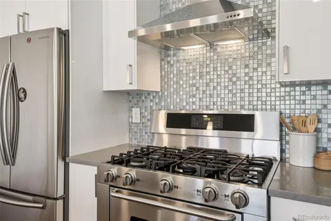 a white stove top oven sitting inside of a kitchen