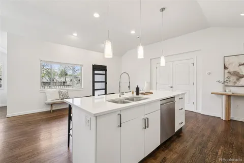 a kitchen with a sink cabinets and wooden floor