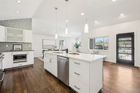 a kitchen with a sink cabinets and wooden floor