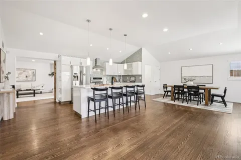 a view of a dining room kitchen with furniture and wooden floor