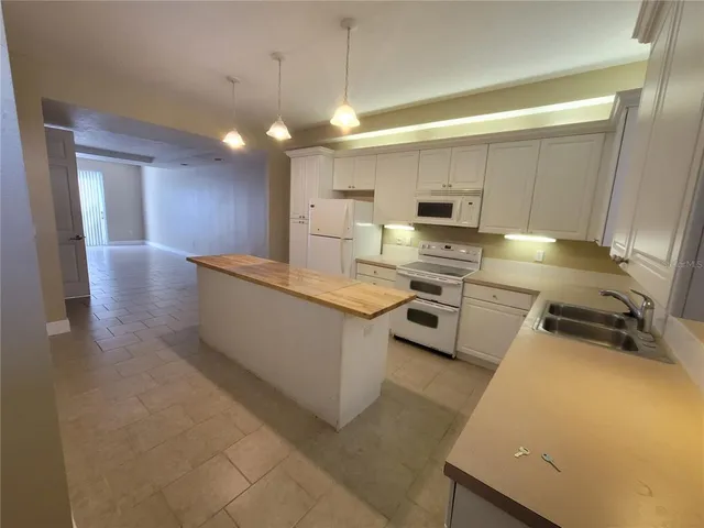 a kitchen with a stove a sink and a refrigerator