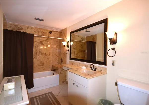 a bathroom with a sink a toilet and bathtub
