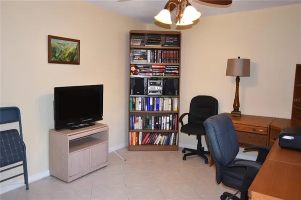 a view of a workspace with furniture and a flat screen tv