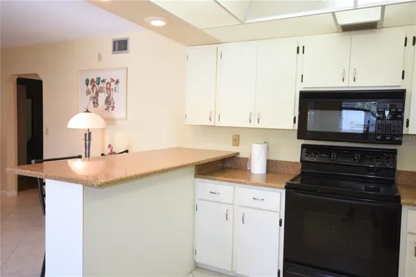 a kitchen with a sink and a stove top oven