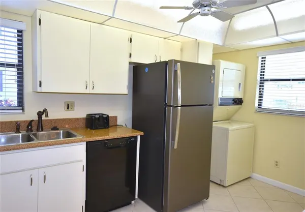 a kitchen with a refrigerator and a sink