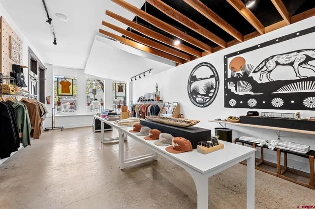 a living room with lots of furniture and a clock