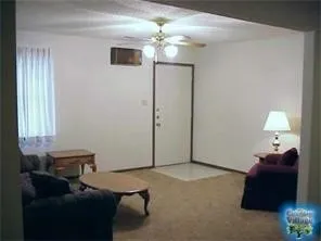 a living room with furniture and a chandelier