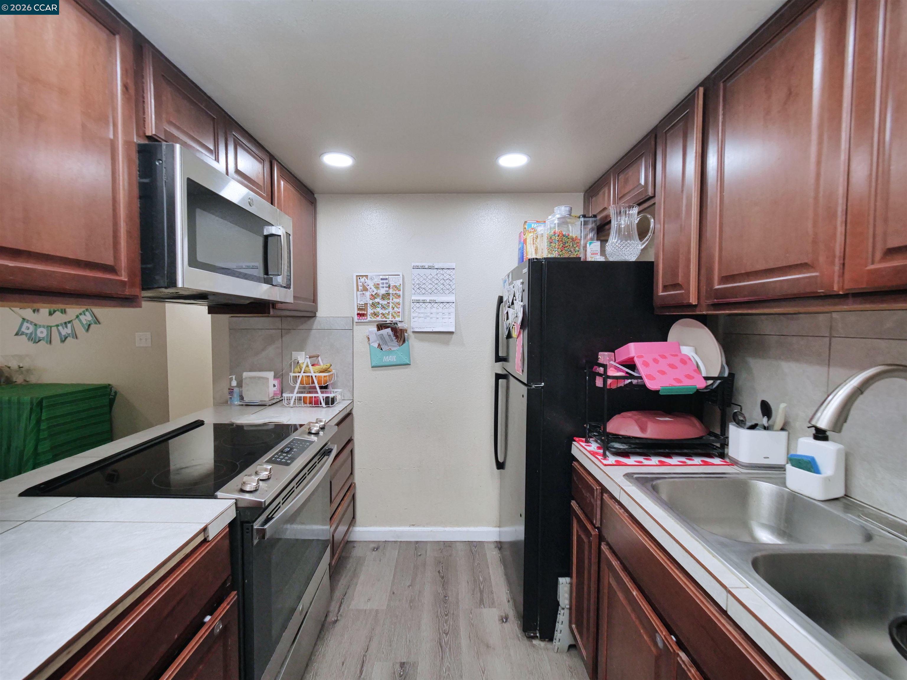 2500 Haddon Avenue Modesto, CA 95354 - Photo 27 of 37 a kitchen with stainless steel appliances granite countertop a sink stove and refrigerator