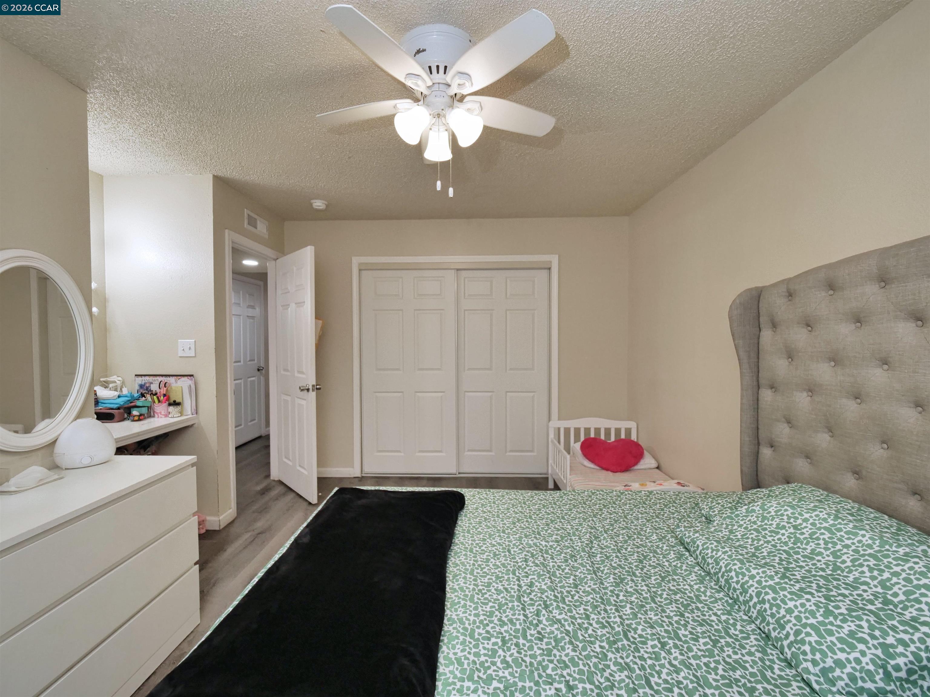 2500 Haddon Avenue Modesto, CA 95354 - Photo 30 of 35 a bedroom with a bed and a chandelier