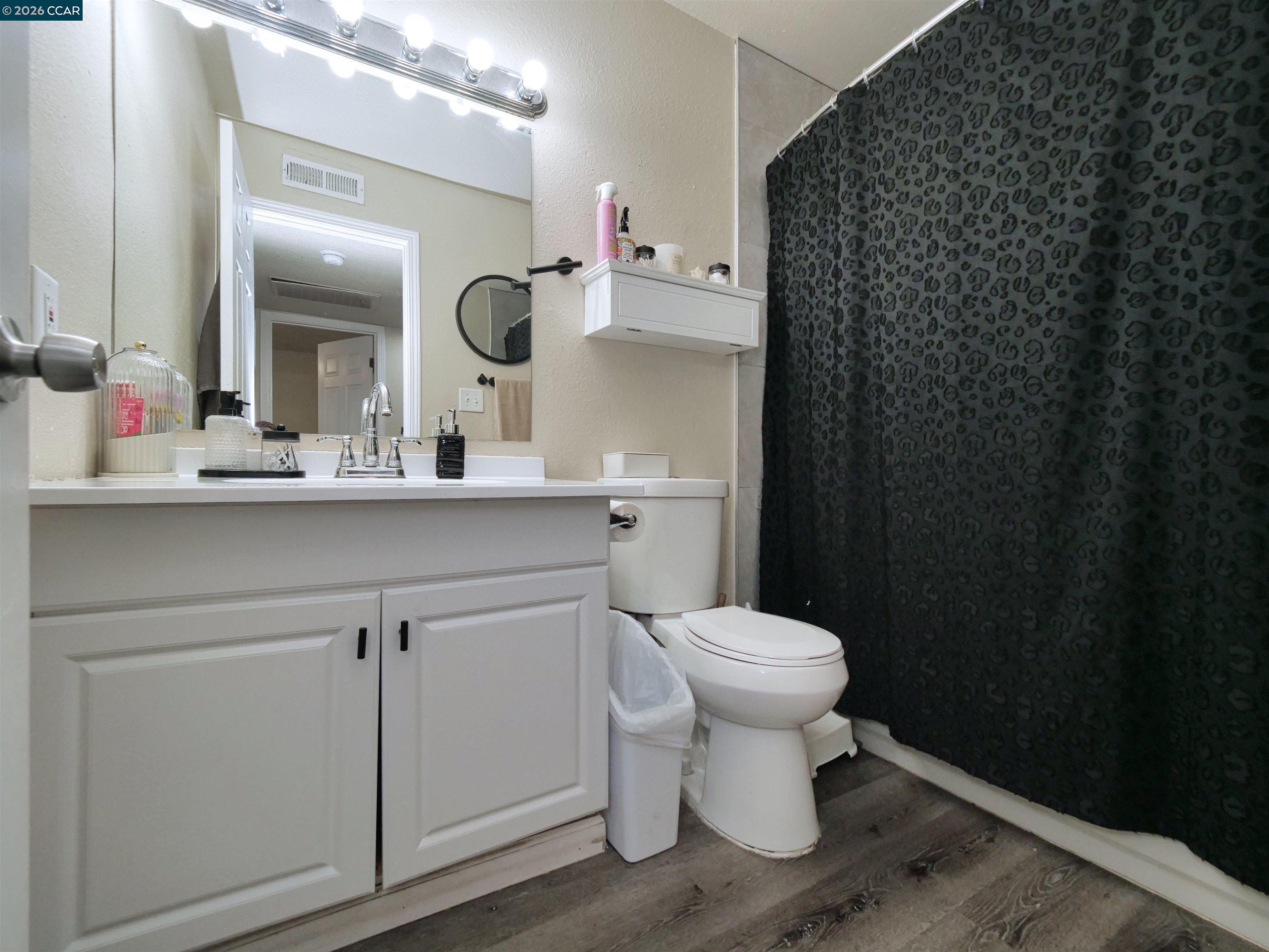2500 Haddon Avenue Modesto, CA 95354 - Photo 31 of 35 a bathroom with a sink a toilet and mirror