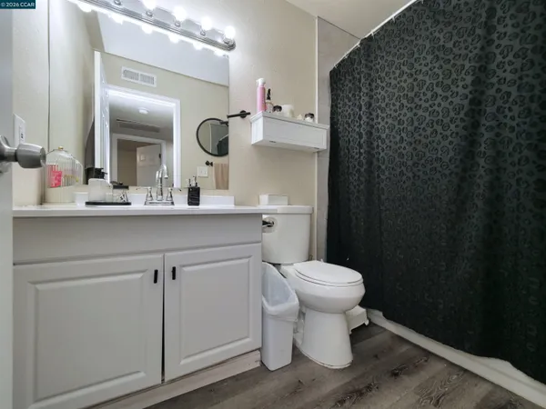 a bathroom with a sink a toilet and mirror