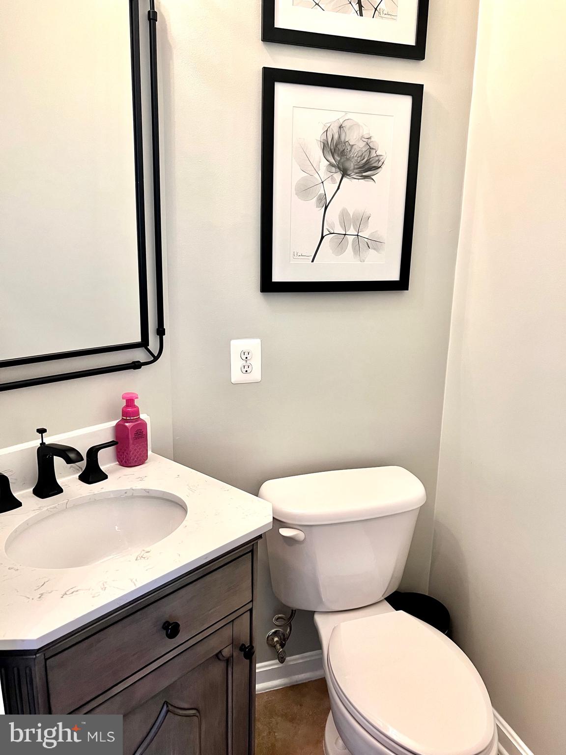 14468 Village High Street, Unit 148 Gainesville, VA 20155 - Photo 13 of 14 a bathroom with a toilet sink and mirror