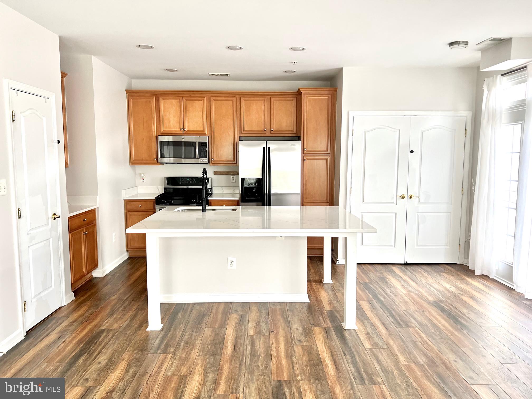14468 Village High Street, Unit 148 Gainesville, VA 20155 - Photo 6 of 14 a living room with stainless steel appliances furniture and a large window