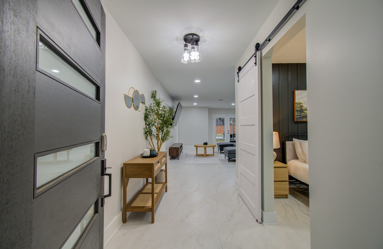 5539 Edith Street Houston, TX 77081 - Photo 1 of 50 a hallway with a couch and chandelier