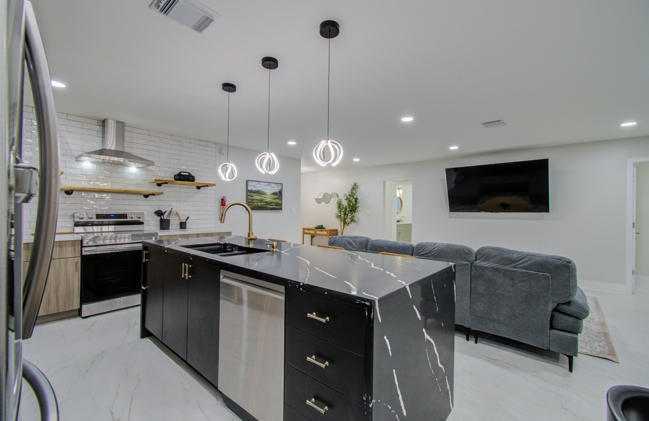 5539 Edith Street Houston, TX 77081 - Photo 11 of 50 a kitchen with stainless steel appliances granite countertop a sink a stove and a refrigerator