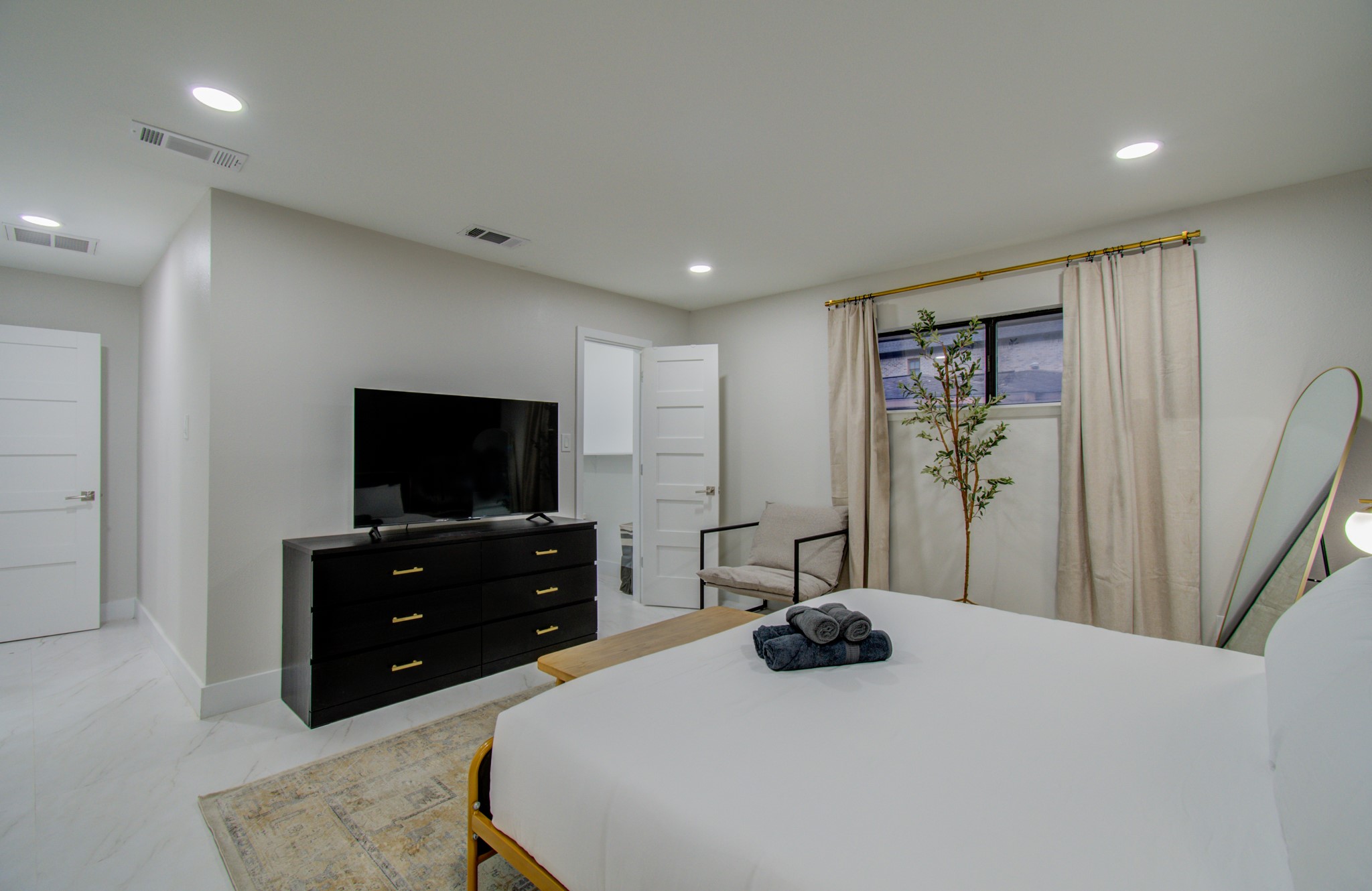 5539 Edith Street Houston, TX 77081 - Photo 16 of 50 a bedroom with a bed and a flat screen tv