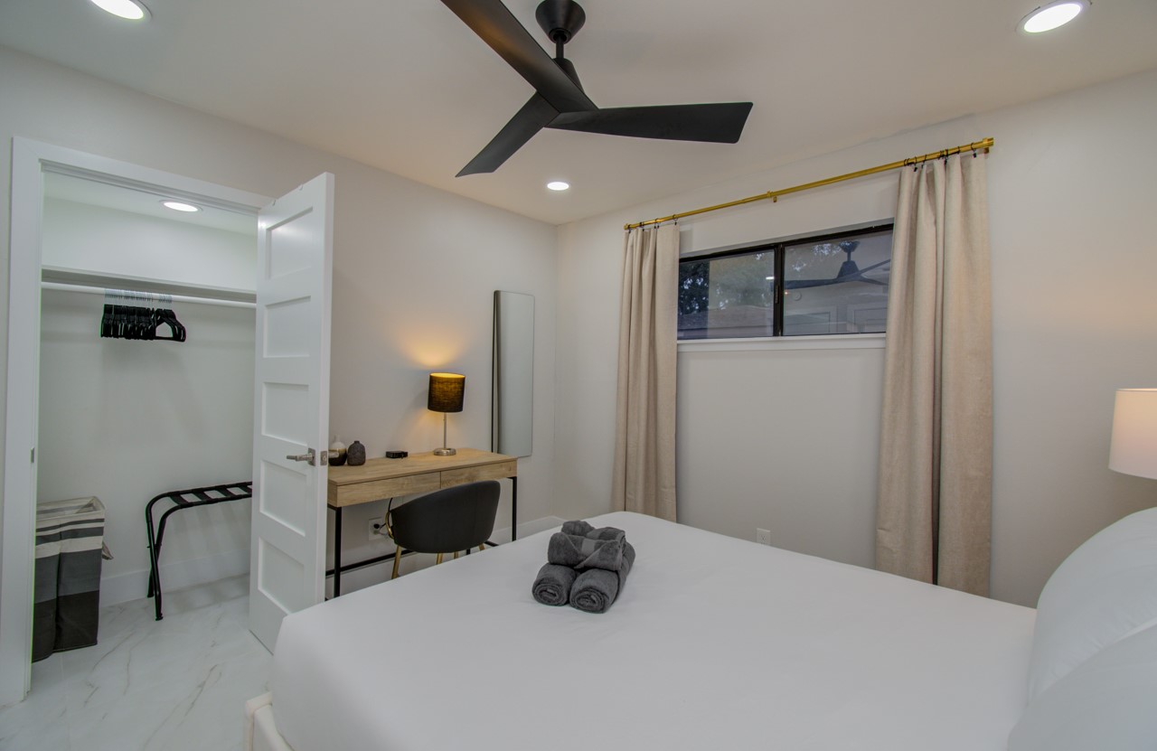 5539 Edith Street Houston, TX 77081 - Photo 24 of 50 a bedroom with a bed a table and painting