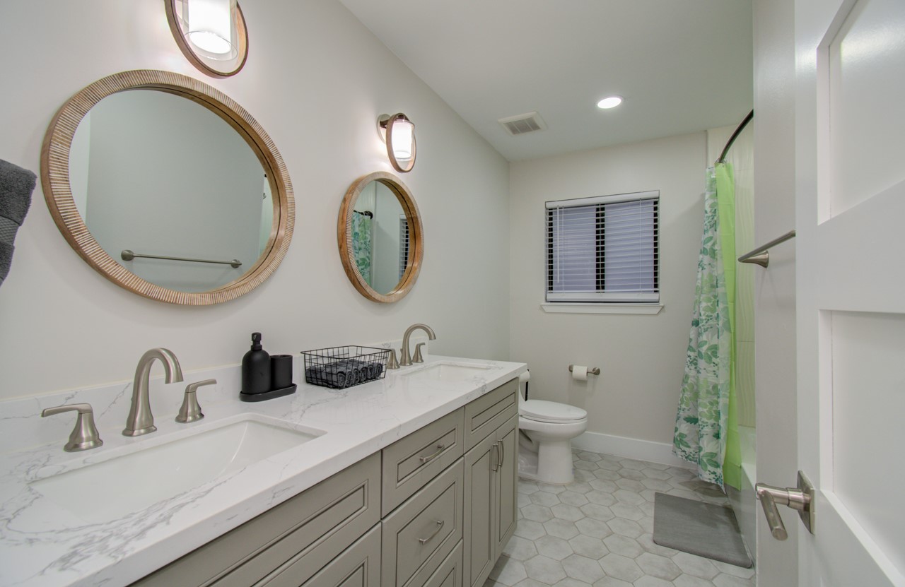 5539 Edith Street Houston, TX 77081 - Photo 25 of 50 a bathroom with a double vanity sink and a mirror