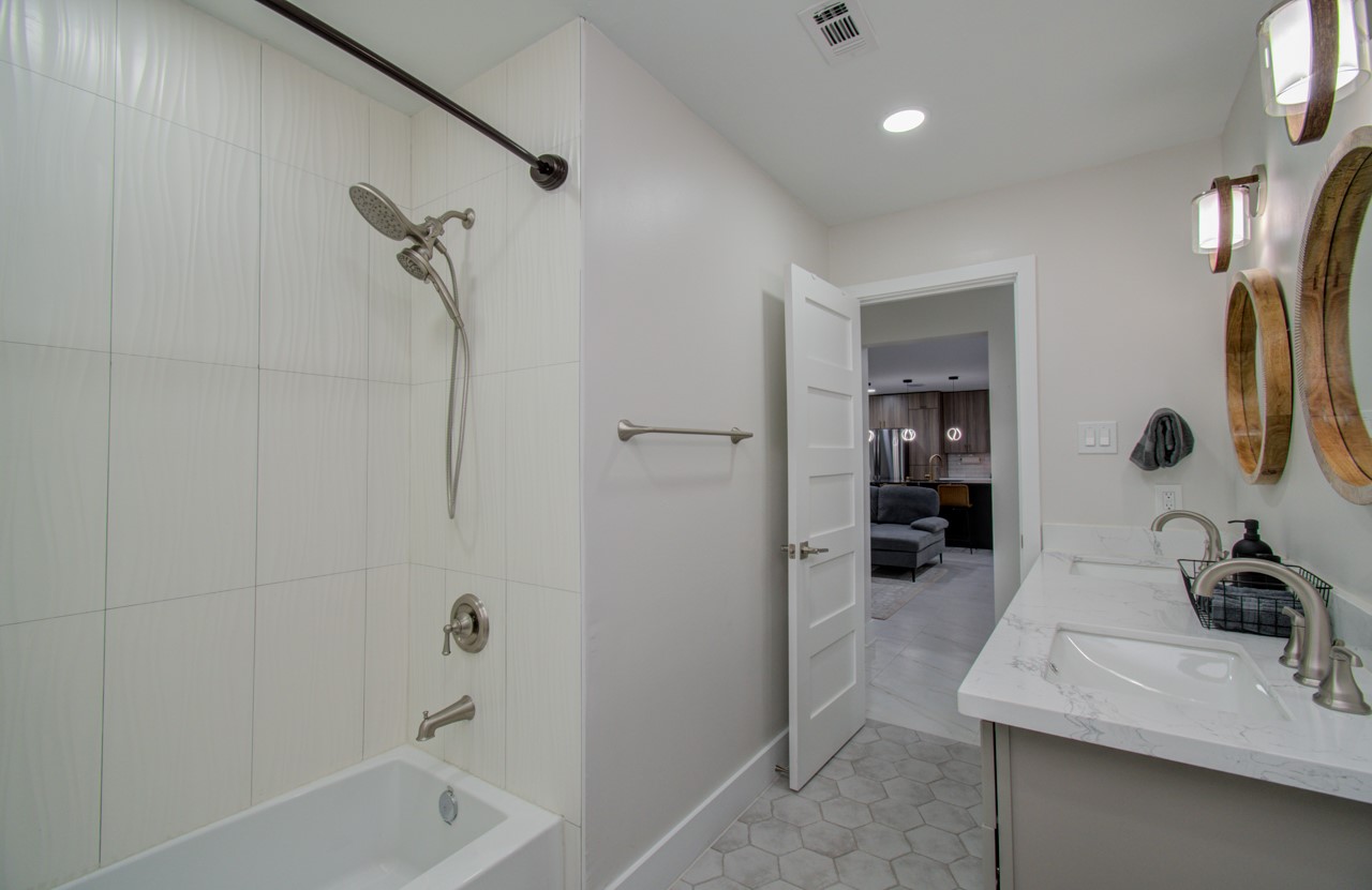 5539 Edith Street Houston, TX 77081 - Photo 26 of 50 a bathroom with a sink double vanity and tub