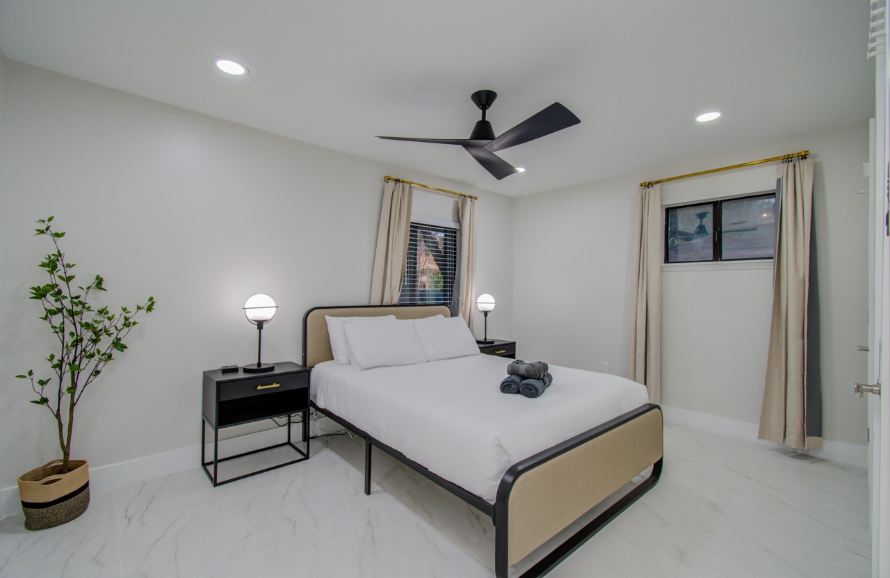 5539 Edith Street Houston, TX 77081 - Photo 28 of 50 a bedroom with a bed and a potted plant