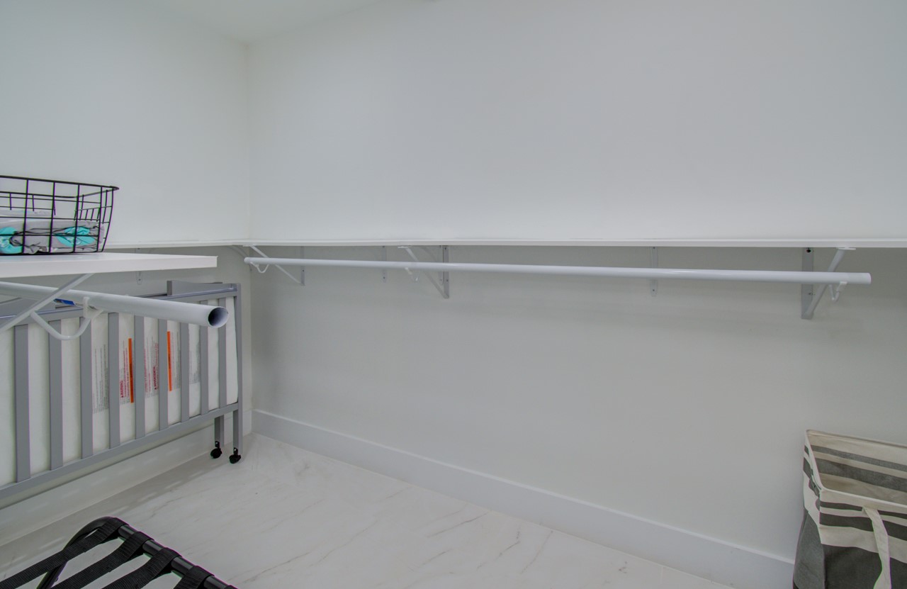 5539 Edith Street Houston, TX 77081 - Photo 31 of 50 a view of utility room with racks on the wall