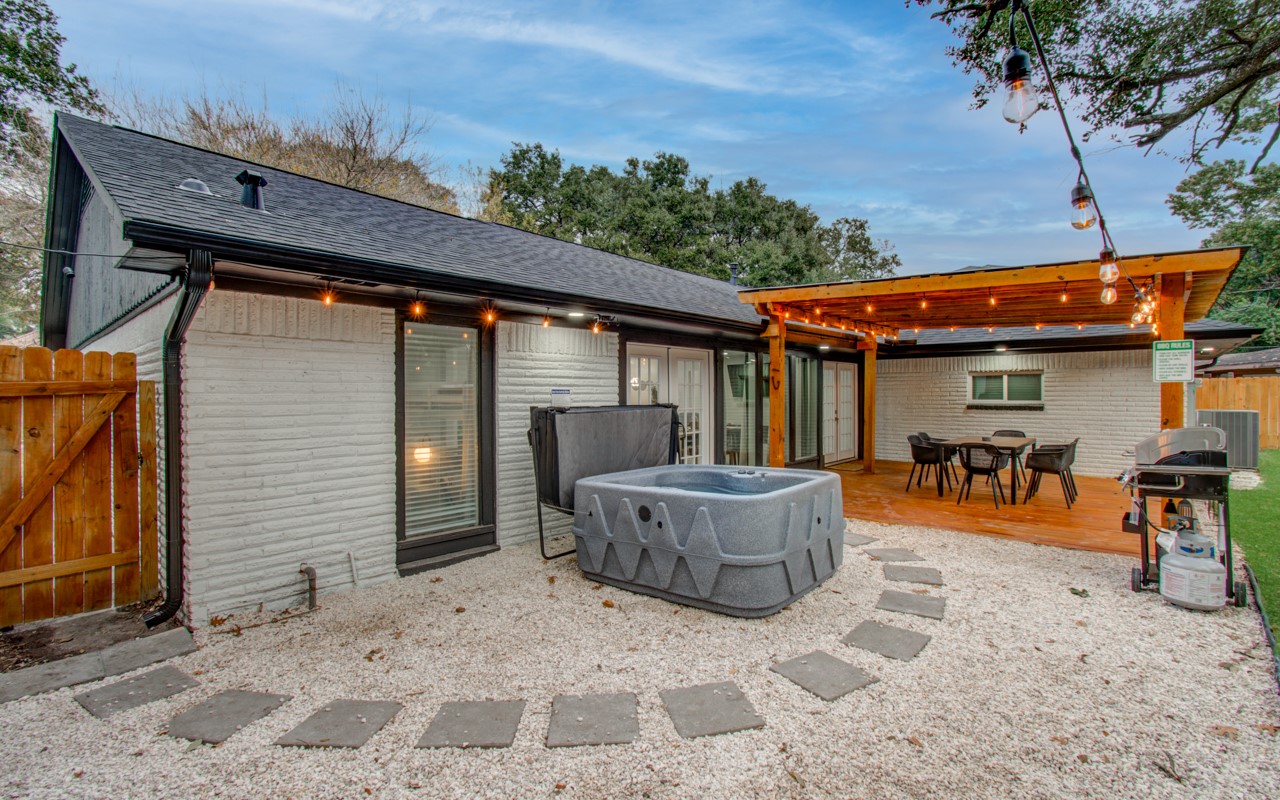 5539 Edith Street Houston, TX 77081 - Photo 36 of 50 a view of a patio with a table and chairs and potted plants