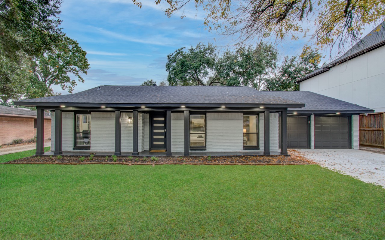 5539 Edith Street Houston, TX 77081 - Photo 45 of 50 a front view of a house with a garden and yard