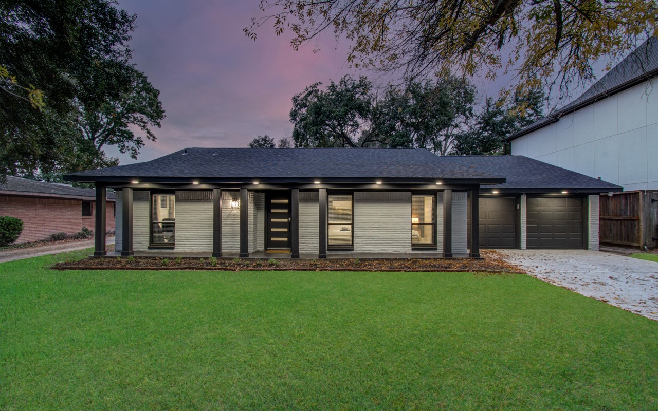 5539 Edith Street Houston, TX 77081 - Photo 47 of 50 a front view of a house with a yard and trees