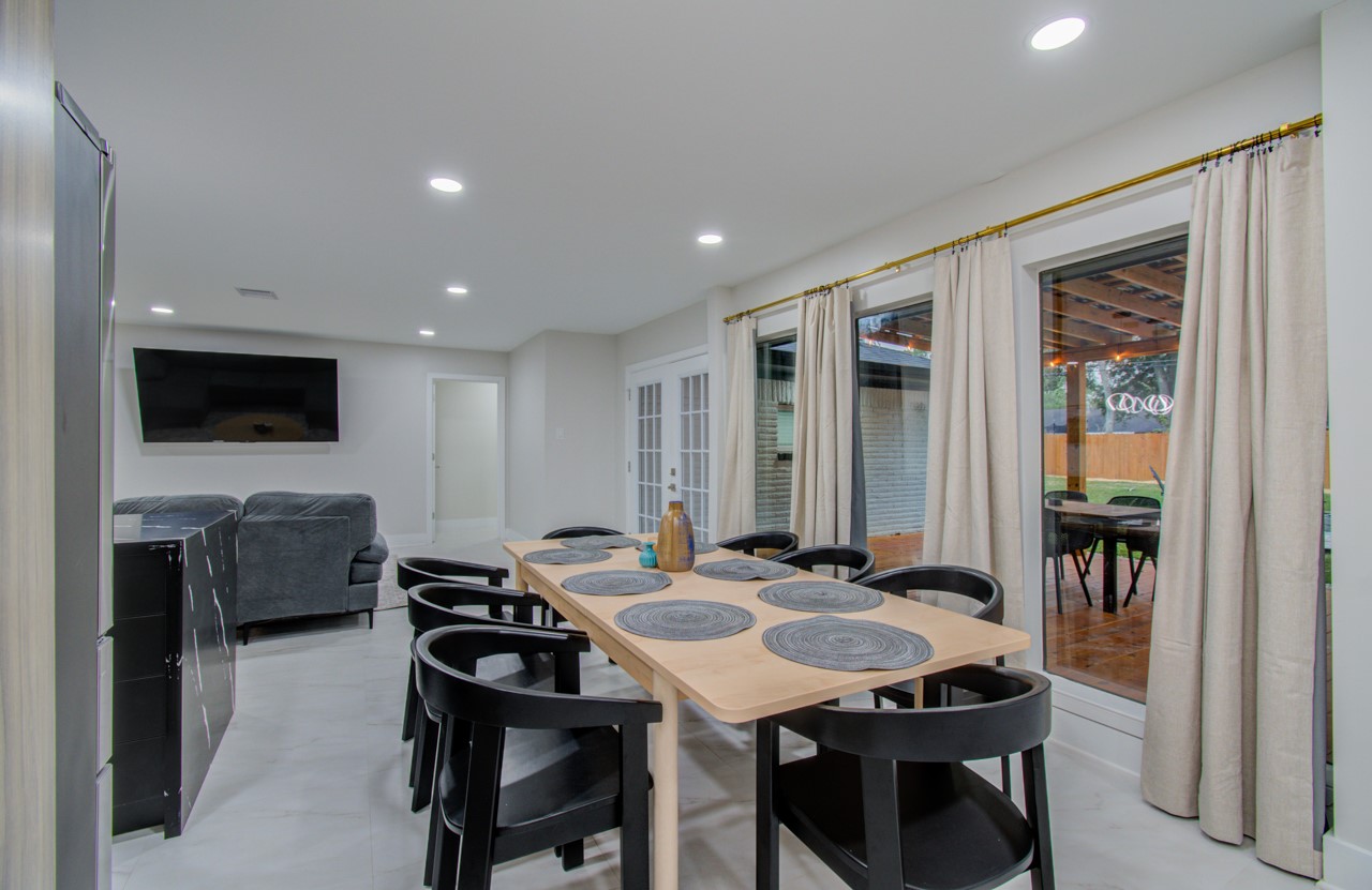 5539 Edith Street Houston, TX 77081 - Photo 7 of 50 a view of a a dining room with furniture window and wooden floor