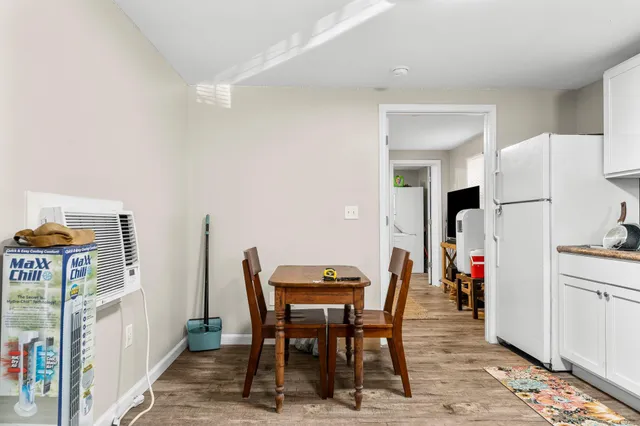 a view of a workspace with furniture and wooden floor
