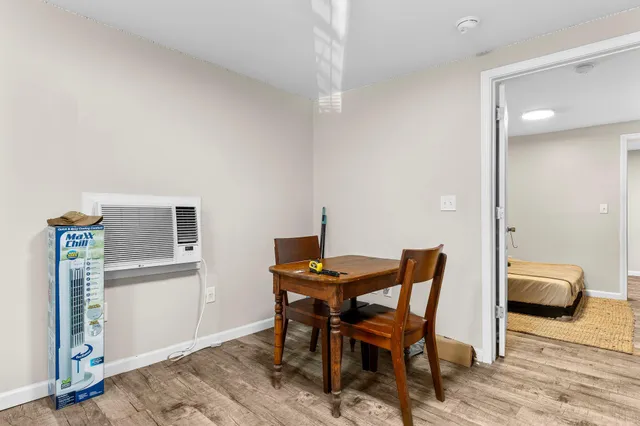 a kitchen with a dining table chairs and refrigerator