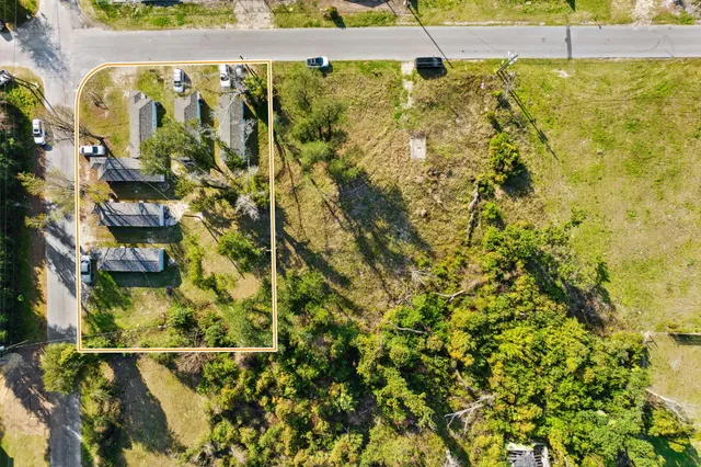 a backyard of a house with lots of green space and plants