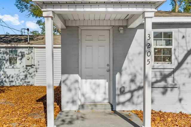 a living room with flat screen tv and outdoor view