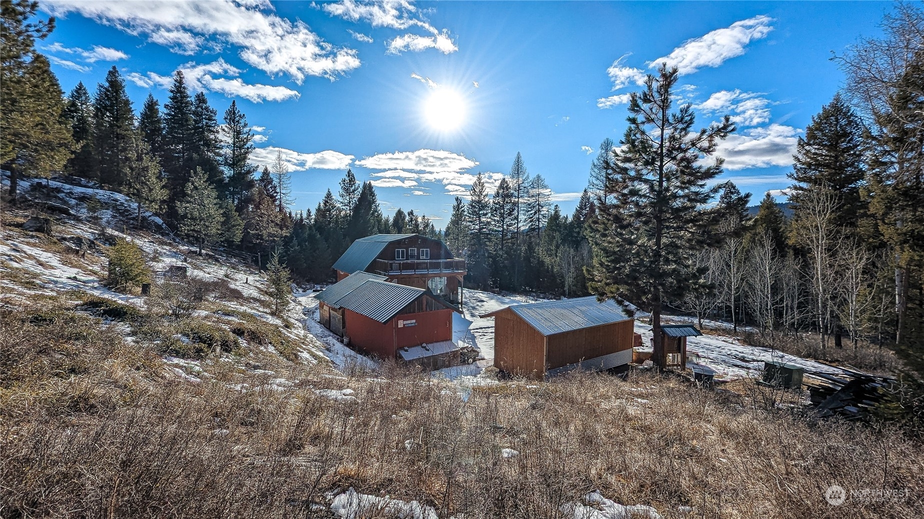740 Cape Labelle Road Tonasket, WA 98855 - Photo 1 of 40 a view of a house with a yard and sitting area