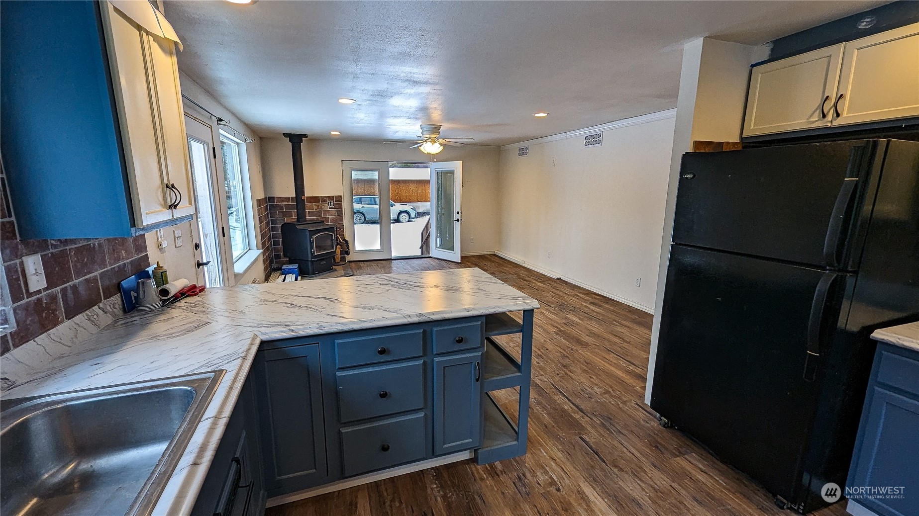740 Cape Labelle Road Tonasket, WA 98855 - Photo 11 of 40 a kitchen with a refrigerator and a sink