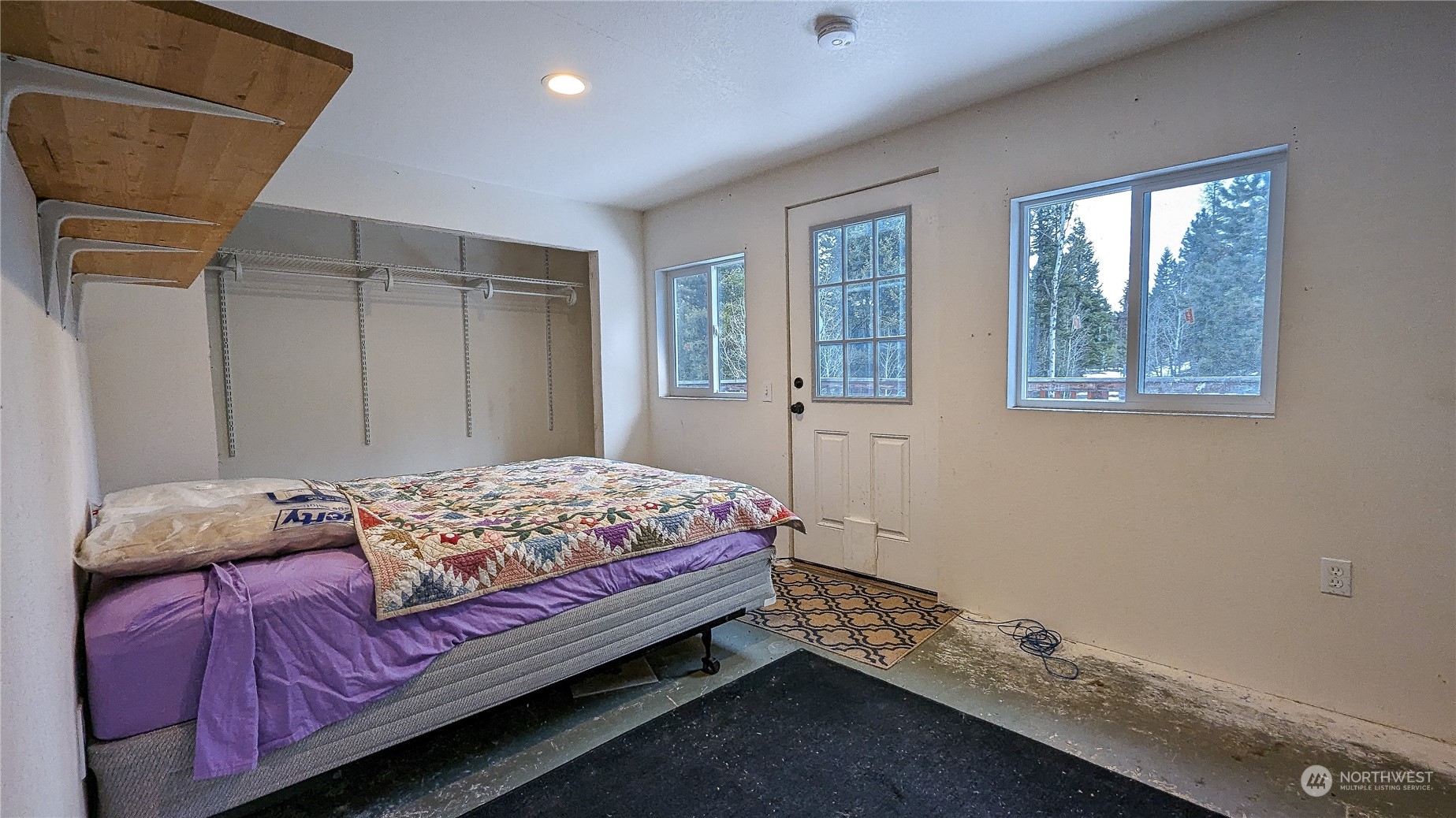 740 Cape Labelle Road Tonasket, WA 98855 - Photo 23 of 40 a bedroom with a bed and a window
