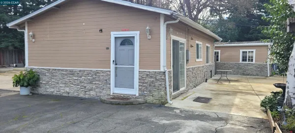 a view of a house with a yard and garage