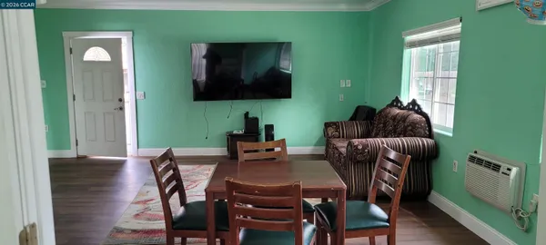 a dining room with furniture and a window