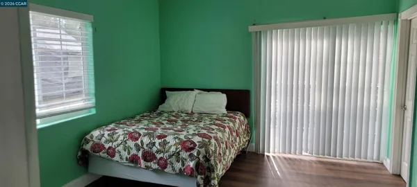 a bed sitting in a bedroom next to a window