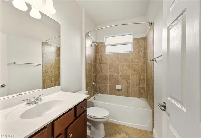 a bathroom with a sink a toilet and shower a mirror