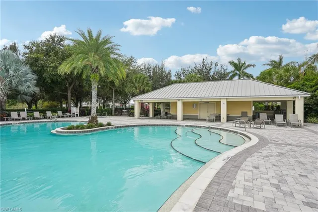 a view of a house with swimming pool and sitting area