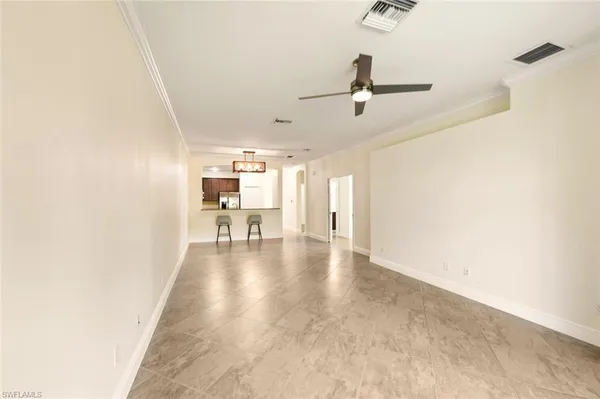 a kitchen with stainless steel appliances kitchen island granite countertop a refrigerator and a sink