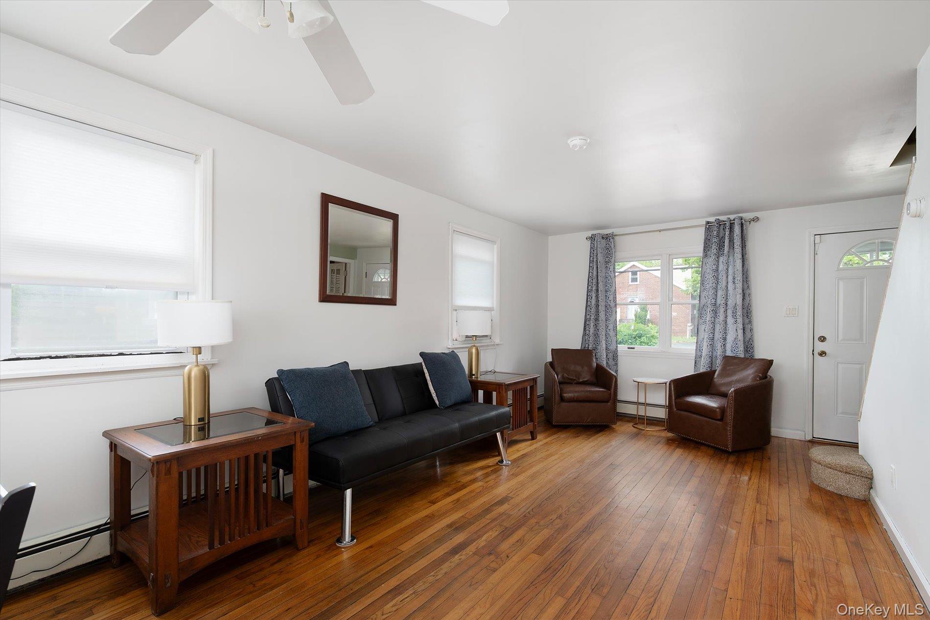 675 Little E Neck Road West Babylon, NY 11704 - Photo 4 of 20 a living room with furniture and a wooden floor