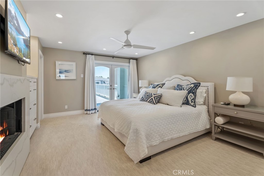 4403 Seashore Drive Newport Beach, CA 92663 - Photo 30 of 69 a bedroom with a bed and a fireplace