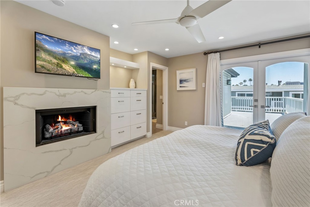 4403 Seashore Drive Newport Beach, CA 92663 - Photo 31 of 69 a bed room with a bed and a fireplace