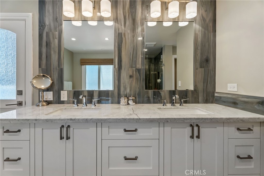 4403 Seashore Drive Newport Beach, CA 92663 - Photo 33 of 69 a bathroom with a granite countertop sink a mirror and a vanity