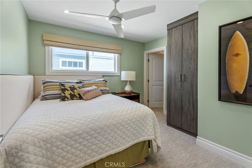 4403 Seashore Drive Newport Beach, CA 92663 - Photo 36 of 69 a bedroom with a bed a mirror on the dresser and a window