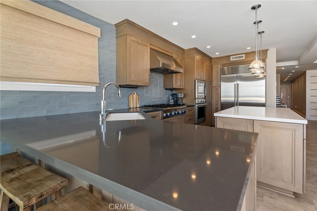 4403 Seashore Drive Newport Beach, CA 92663 - Photo 54 of 69 a kitchen with stainless steel appliances granite countertop a sink a stove and a refrigerator